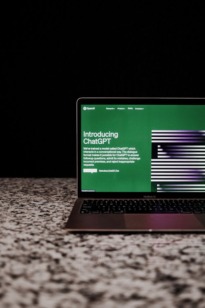 About Laptop showing ChatGPT interface on a marble surface, showcasing AI technology.